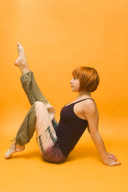 Red girl performing yoga asana