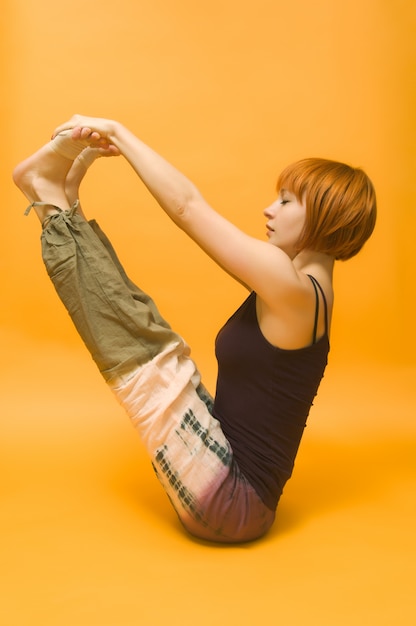 Free photo red girl performing yoga asana