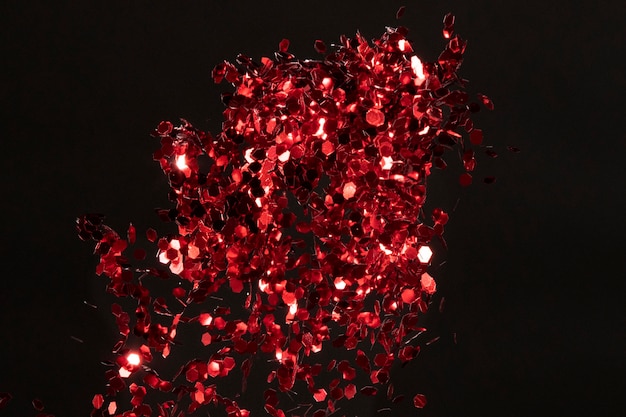 Red glitter composition on black background