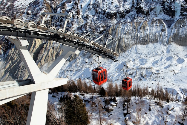 Red gondolas in alpine mountain in winter