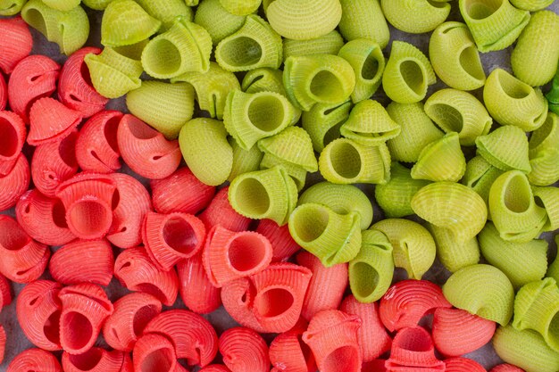 Red and green pastas in colorful sauces. 