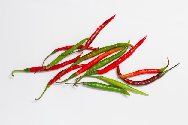 Red and green peppers on plain background