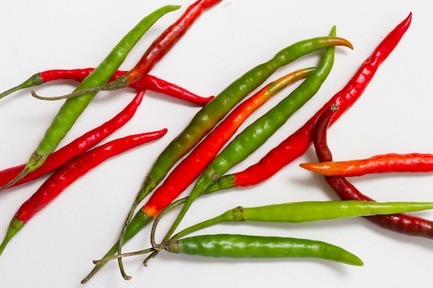Red and green peppers on plain background