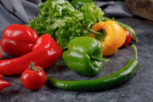 Red, green and yellow peppers with lettuce.