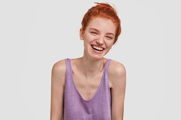 Free photo red haired freckled female trembles from laugh