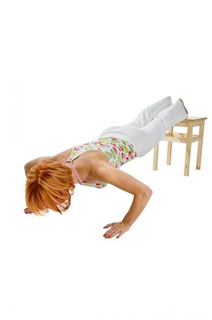 Free photo red haired girl performing fitness exercises