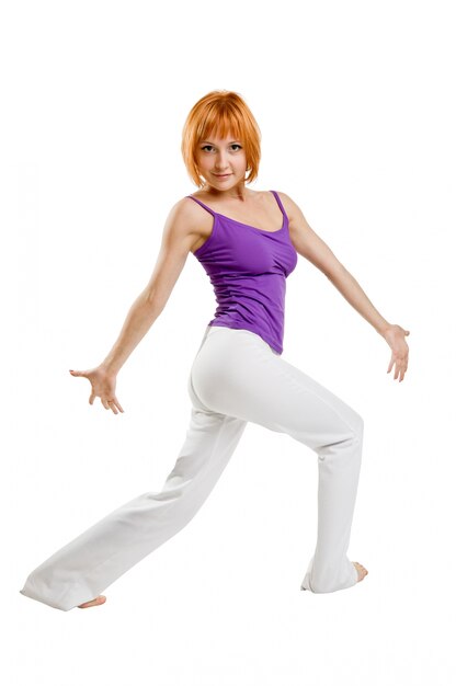 Red haired girl performing fitness exercises