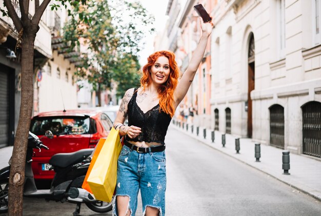 Red-haired woman hailing taxi