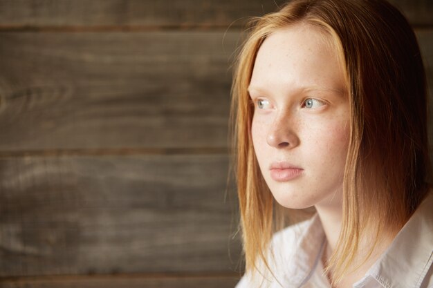 Red-haired woman sitting in cafe