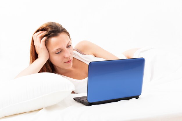 red-haired woman with blue laptop