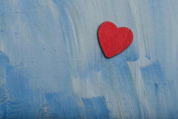 Red heart on a blue wall