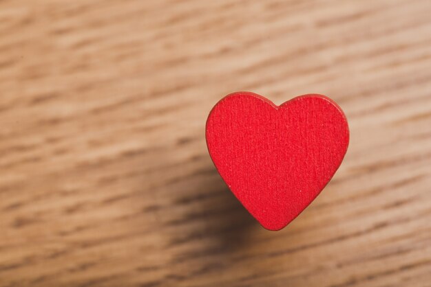 Red heart close up on a wooden table