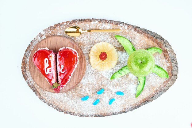 Red heart shape valentine cake with fruits.