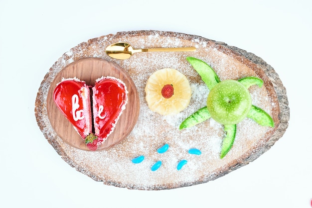 Red heart shape valentine cake with fruits.