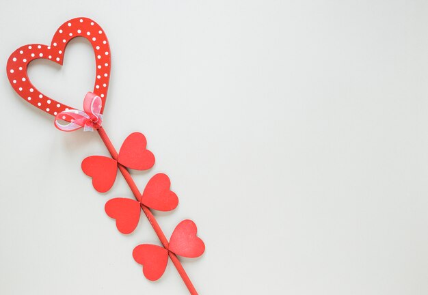 Red heart on stick with pink ribbon
