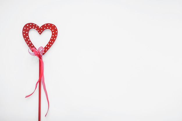 Red heart on stick with ribbon