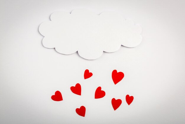 Red hearts falling from a cloud