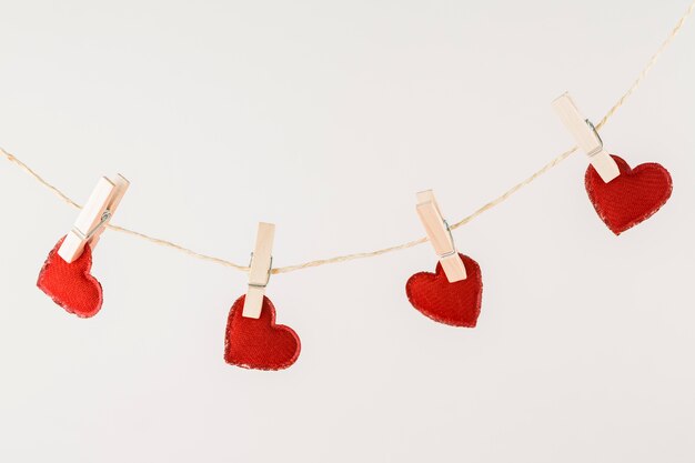 Red hearts hanging on rope