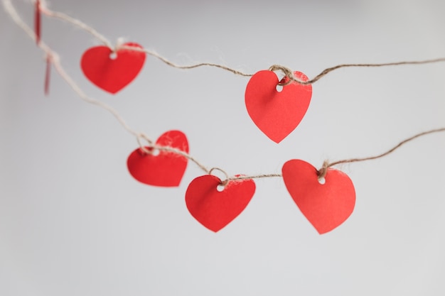 Red hearts hanging on ropes