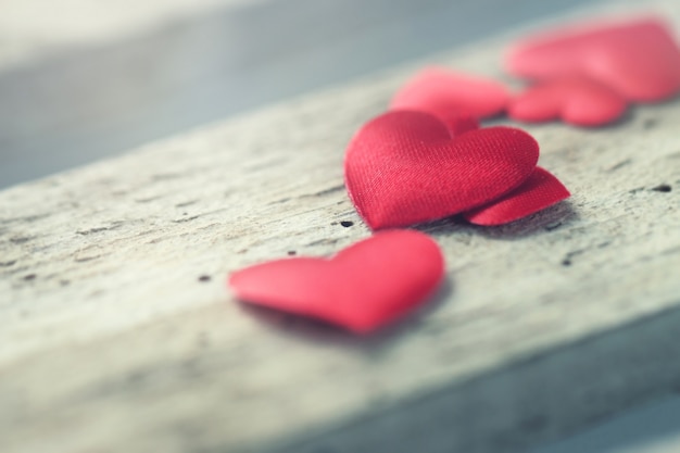 Red hearts on a wooden board