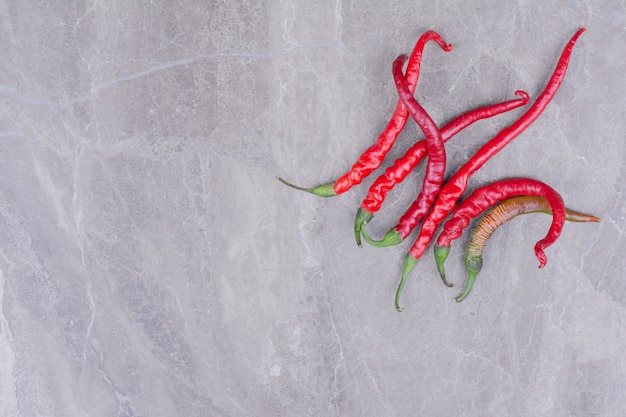 Free photo red hot chili peppers on marble.