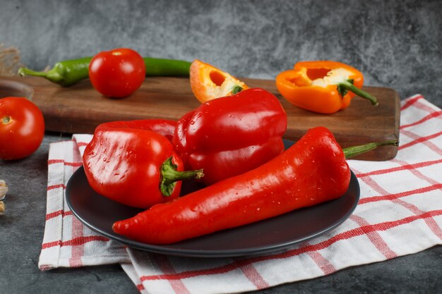 Red hot chilies on a checked towel.