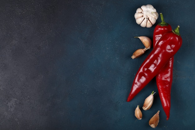 Free photo red hot chilies with garlic gloves.