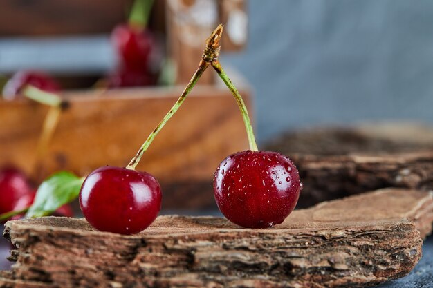 Red juicy cherry berries on a wooden piece