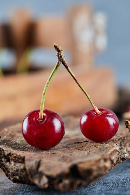 Red juicy cherry berries on a wooden piece