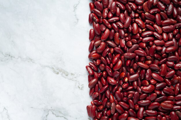 red kidney beans place on white marble background