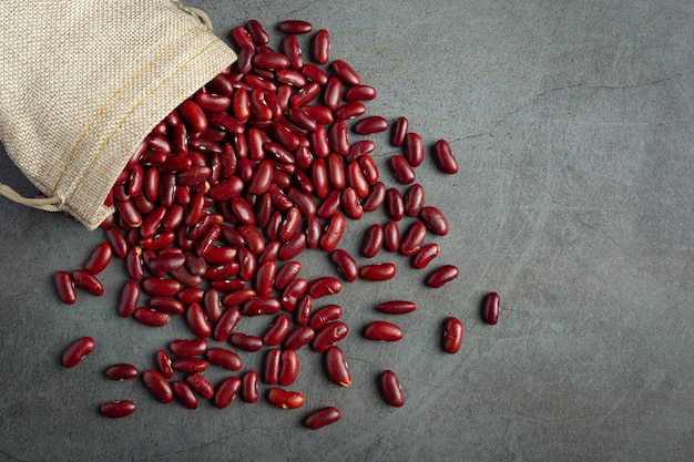 Red kidney beans pour out from sack bag to ground