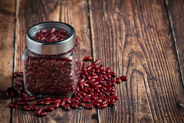 Red kidney beans in a small jar put on wooden floor