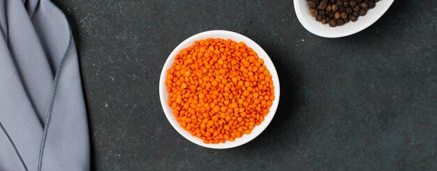 Red lentil beans in a white bowl on the table