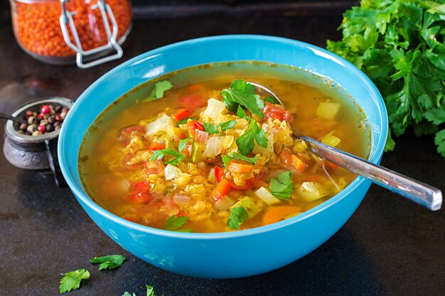 Red lentil soup on dark surface. Healthy eating concept. Vegan food.