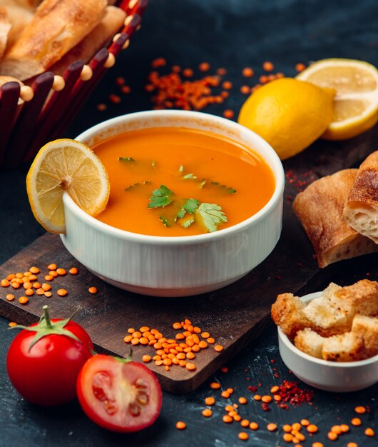 Red lentil soup with a slice of lemon and breadcrumbs