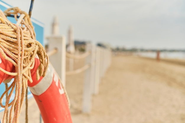 Free photo red lifebuoy on the beach selective focus with space for text