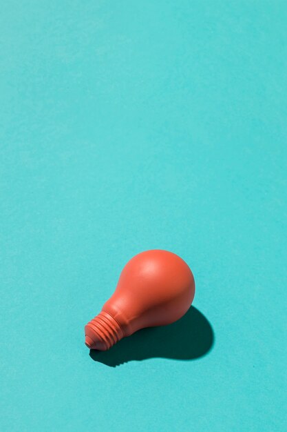 Red light bulb on blue background