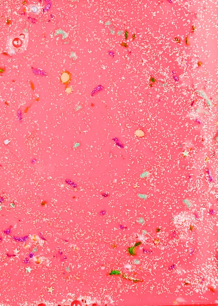 Red liquid with colourful crumbs