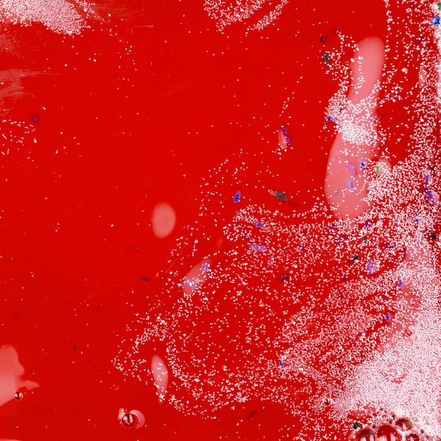 Red liquid with silver crumbs