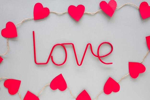 Red Love inscription with paper hearts 