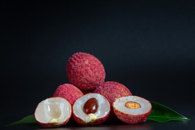 Red lychee fruit placed in a basket.