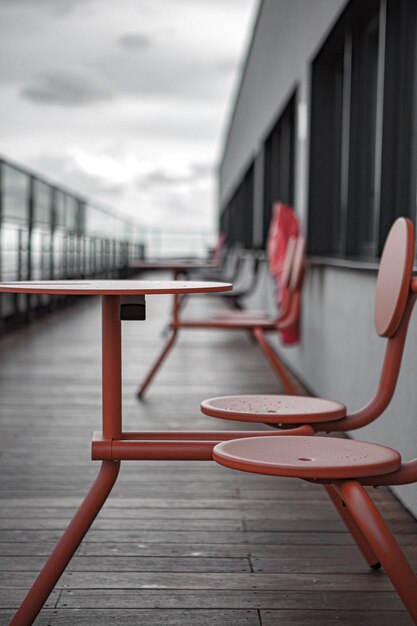 Red metal chairs and tables on dock