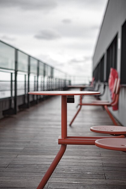 Red metal table and chairs on wooden deck