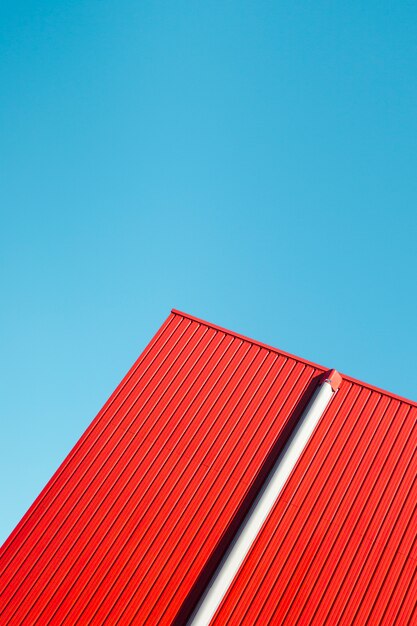 Red metallic wall with sky