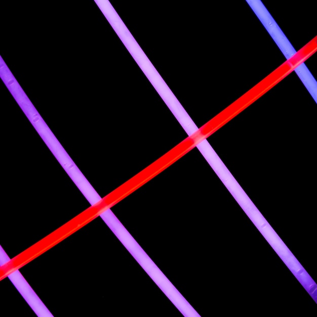 Red neon tubes on purple neon lights on dark background