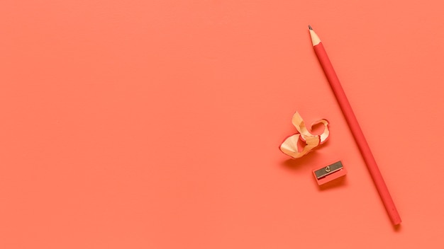 Red office supplies on colored surface