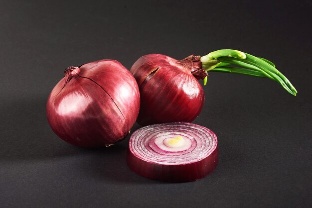 Red onions whole, isolated on a black.