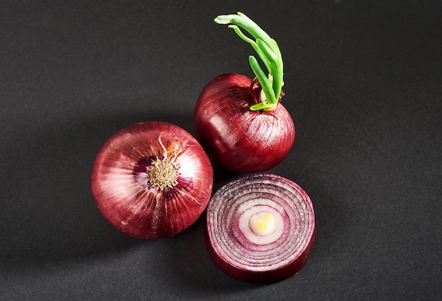 Red onions whole, isolated on a black.