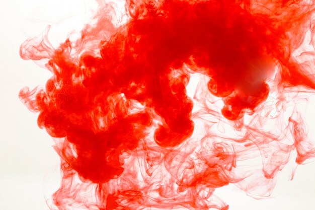 Red paint diffusing in water