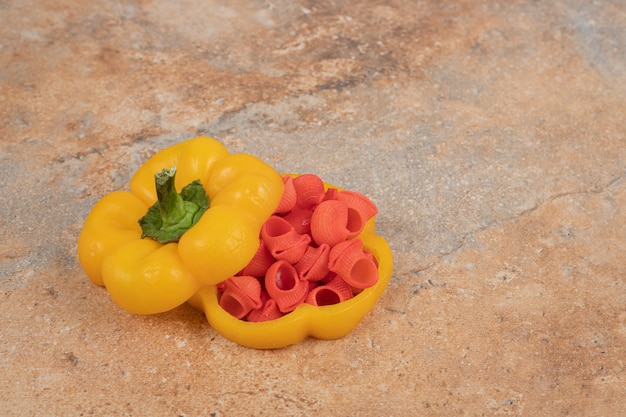 Free photo red pasta in bell pepper on orange background